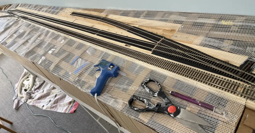 Fiber tape installed over cardboard web forms a solid base for the hardshell scenery